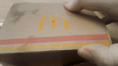 a person is opening a mcdonald 's box with a canadian flag on it