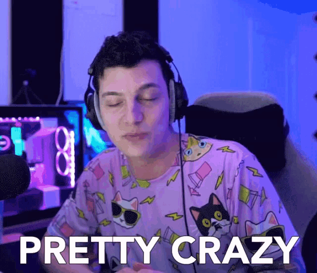 a man wearing headphones says pretty crazy in front of a computer