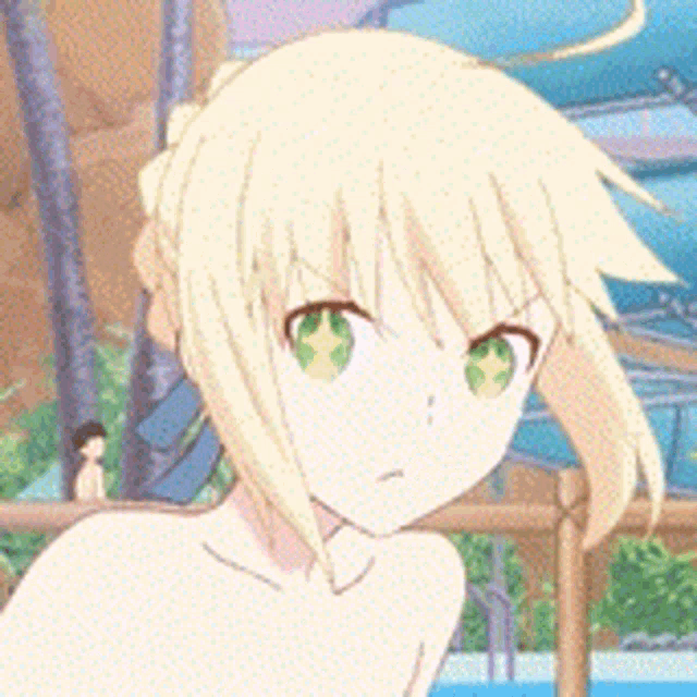 a girl with blonde hair and green eyes is standing in front of a water slide .
