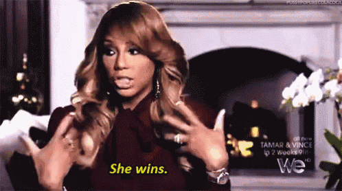 a woman says she wins in front of a fireplace .