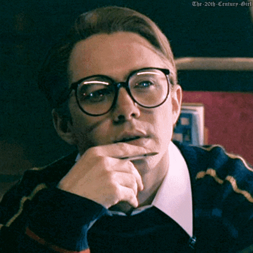 a man wearing glasses and a sweater has the 20th century girl written on the bottom right