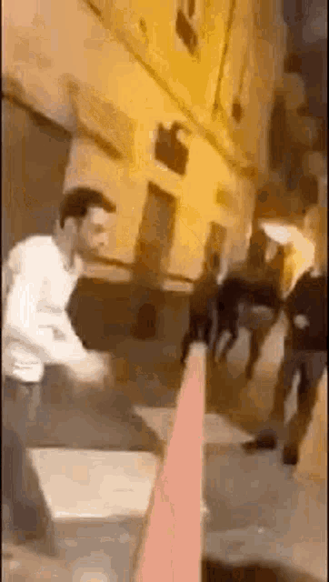 a man is standing next to a cone on a sidewalk .