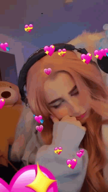 a girl with headphones on her head is surrounded by pink hearts