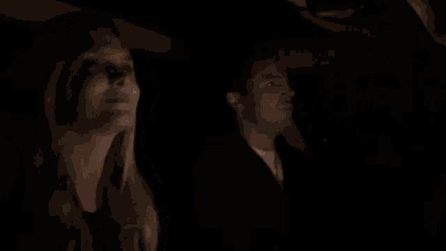 a man and a woman are sitting in the back seat of a car .