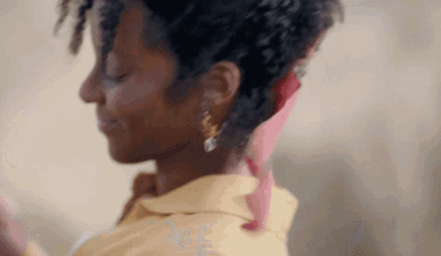 a close up of a woman 's face with a red scarf around her neck