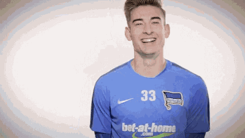 a young man wearing a blue jersey with the number 33 on it