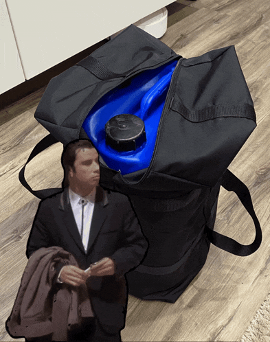 a man in a suit is standing next to a bag with a blue container inside