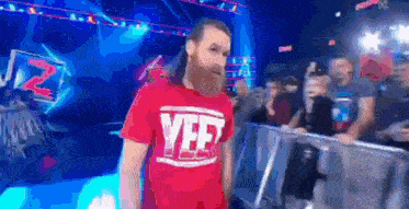 a man with a beard is wearing a red shirt that says yef .