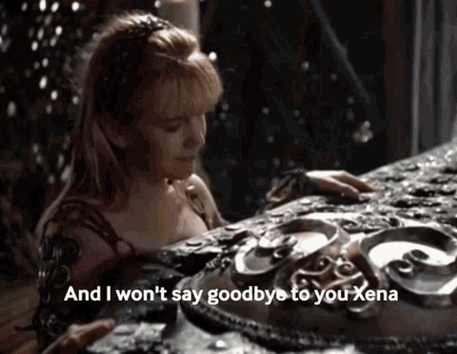 a woman is touching a piece of metal with the words " and i won 't say goodbye to you xena "