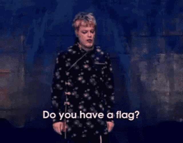a man in a polka dot shirt is asking if he has a flag
