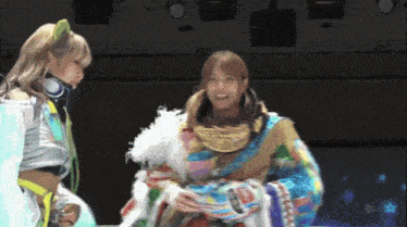 a woman wearing headphones stands next to another woman in a colorful costume