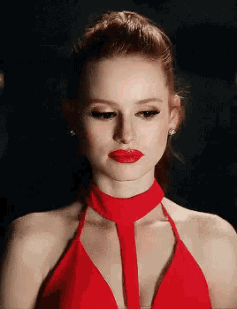 a woman wearing a red dress and red lipstick