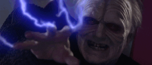 a close up of a person 's face with a blue light coming out of their hand .