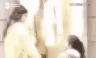 a woman is standing in front of a mirror looking at herself in the mirror .