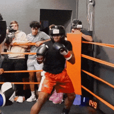a boxer in a ring with a digital clock that says 149