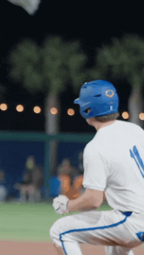 a baseball player wearing a blue helmet and number 11 on his jersey