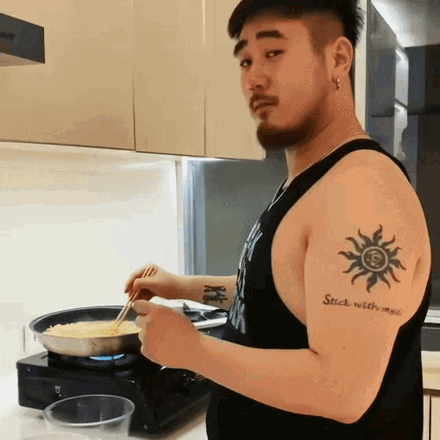a man with a tattoo on his arm that reads stick with me