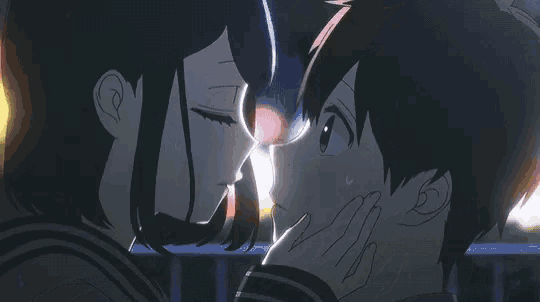 a boy and a girl are touching their noses