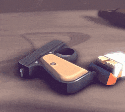 a gun and a pack of cigarettes are laying on a table