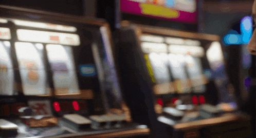 a blurred image of a slot machine with a purple sign that says ' a ' on it