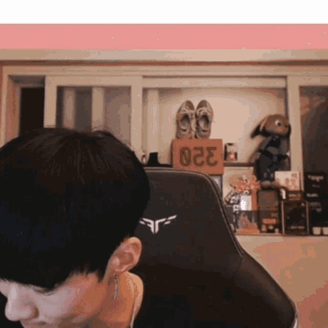 a man is sitting in a chair with the number 023 on the back