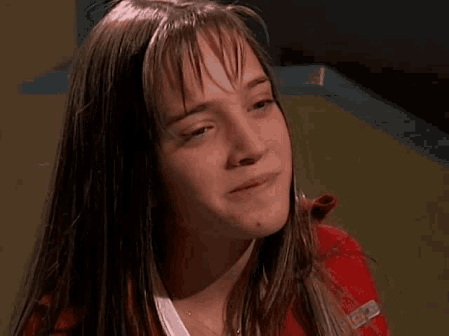 a close up of a young girl 's face with a tear running down her face