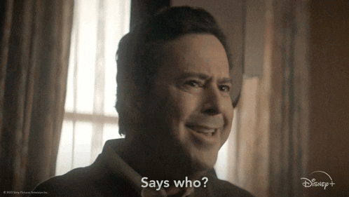 a man is smiling and says who on the screen