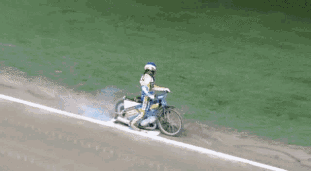 a person is riding a motorcycle on a track with smoke coming out of the tire