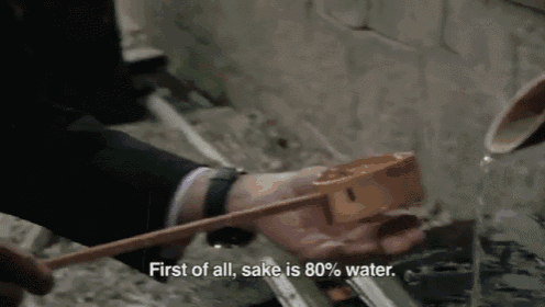 a person is pouring water into a container with the words first of all sake is 80 % water