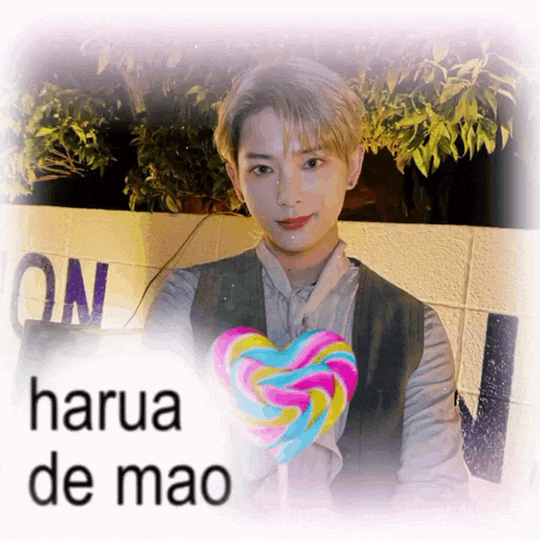 a man holding a lollipop with the name harua de mao on the bottom