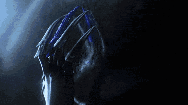 a close up of a person 's hand with a blue claw on it