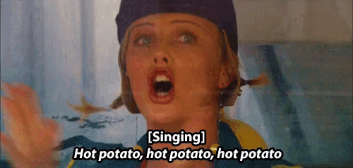 a woman is singing hot potato , hot potato , hot potato with her mouth open .
