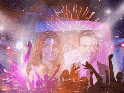 a picture of a man and a woman on a stage with fireworks