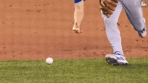 a baseball player is holding a ball in his hand on a baseball field .