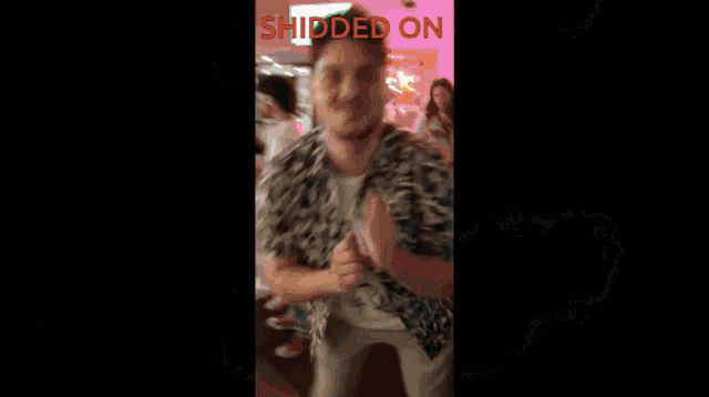 a man is surrounded by fire and the words shidded on are visible