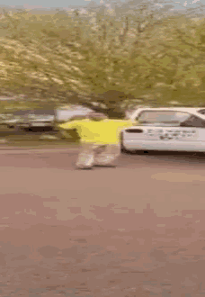 a blurred image of a man riding a skateboard in front of a white car that says ' chase ' on it