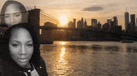 a black and white photo of a woman standing next to a body of water