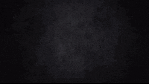 a blurred image of a person 's face with a black helmet on
