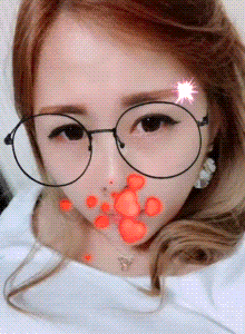 a close up of a woman wearing glasses with hearts on her face
