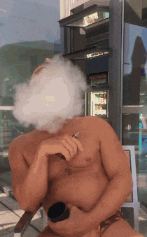 a shirtless man is smoking a cigarette with smoke coming out of his mouth