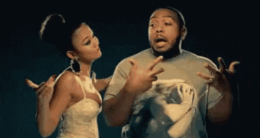 a man and a woman are standing next to each other and the woman is pointing at the man