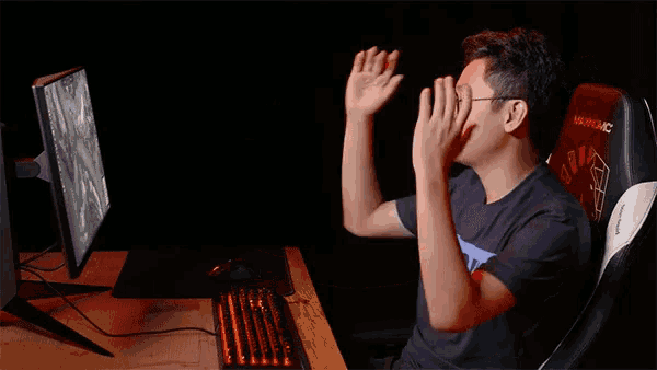 a man sitting in an akracing chair with his arms up