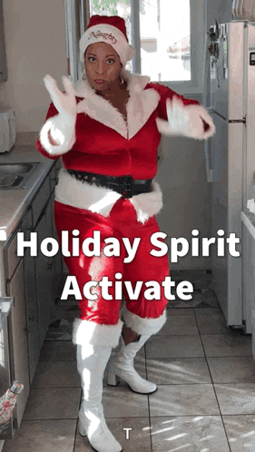 a woman dressed as santa claus is dancing in a kitchen