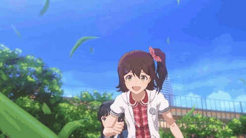 a girl with a bow on her hair is standing next to another girl in a park