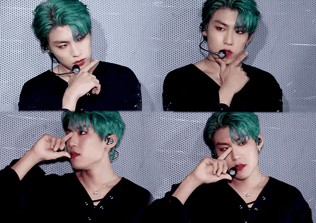 a man with green hair is wearing a black shirt and earphones