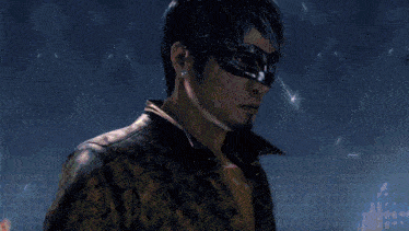 a man in a mask is standing in a dark room with a blue light behind him