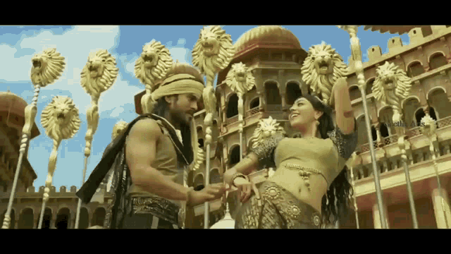 a man and woman are dancing in front of a castle