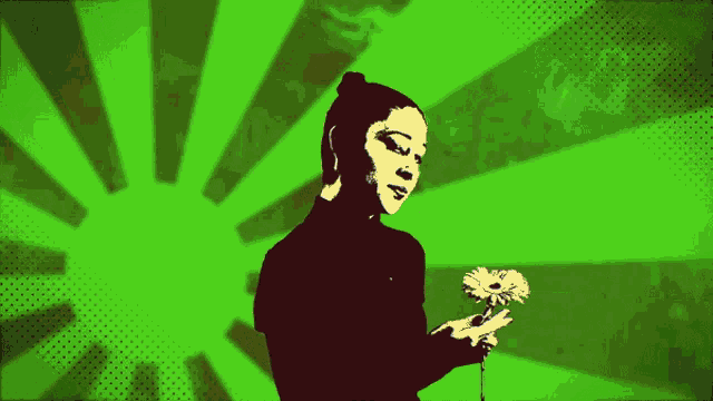 a woman is holding a flower in her hand against a green background