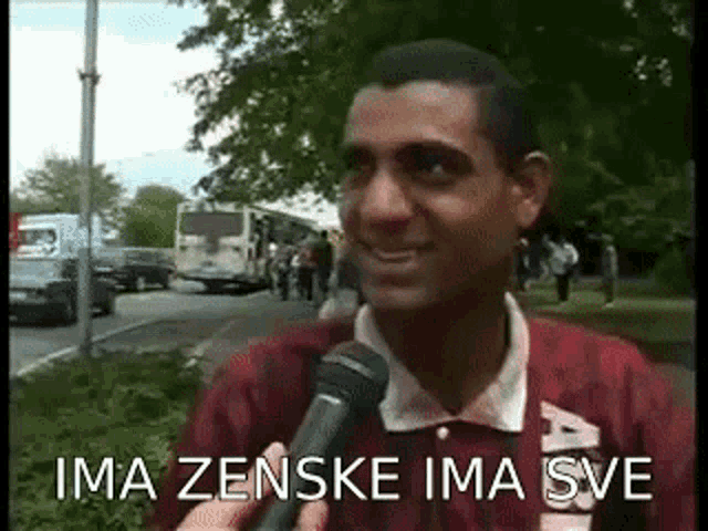 a man is talking into a microphone and the words ima zenske ima sve are on the screen