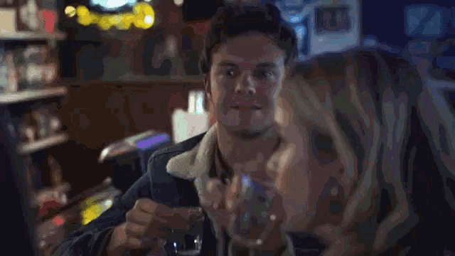 a man and a woman are sitting at a table in a restaurant .
